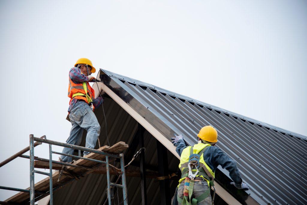 two roofers working with safety lines attached